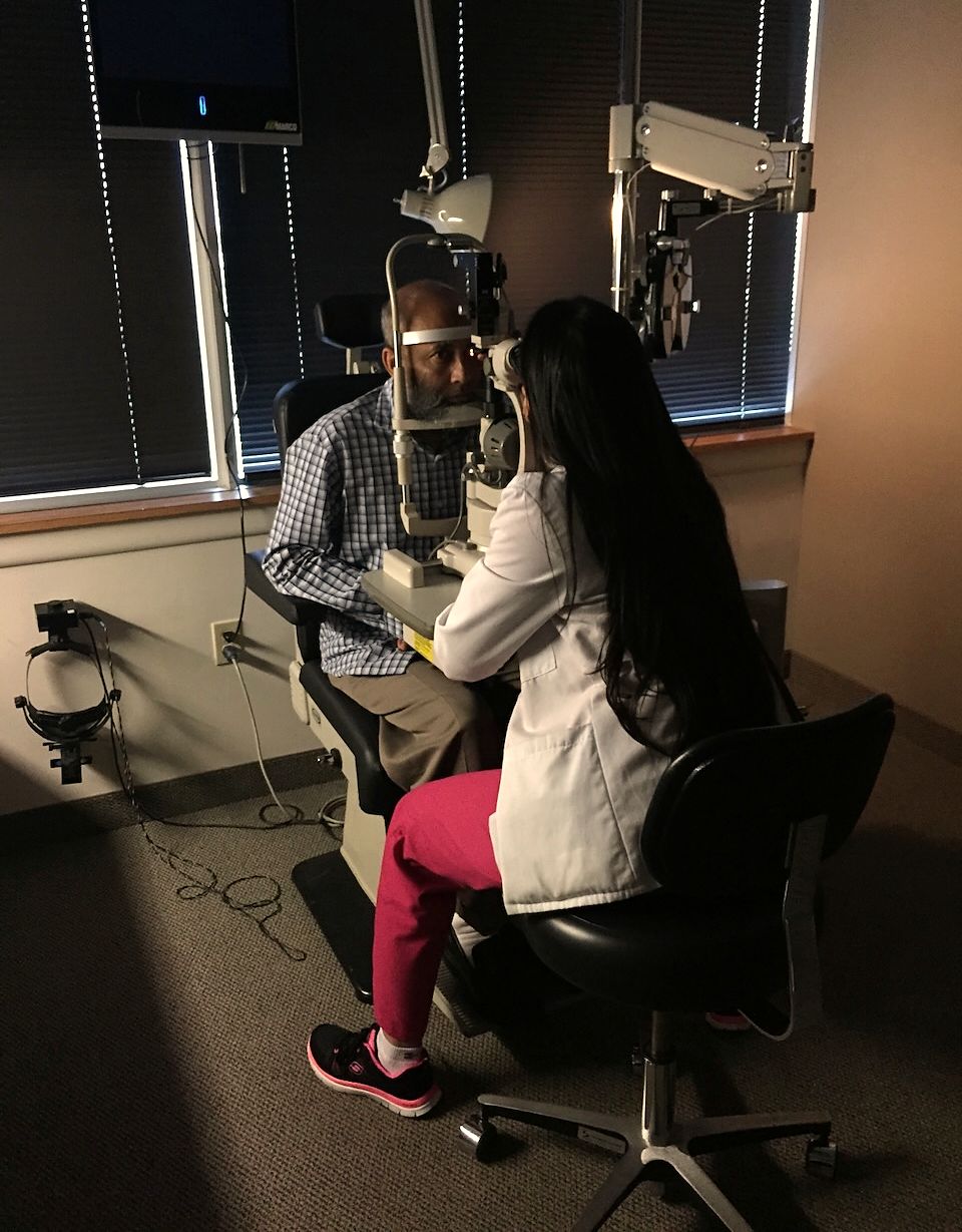 Dr. Rahman examining a patient at the slit lamp.